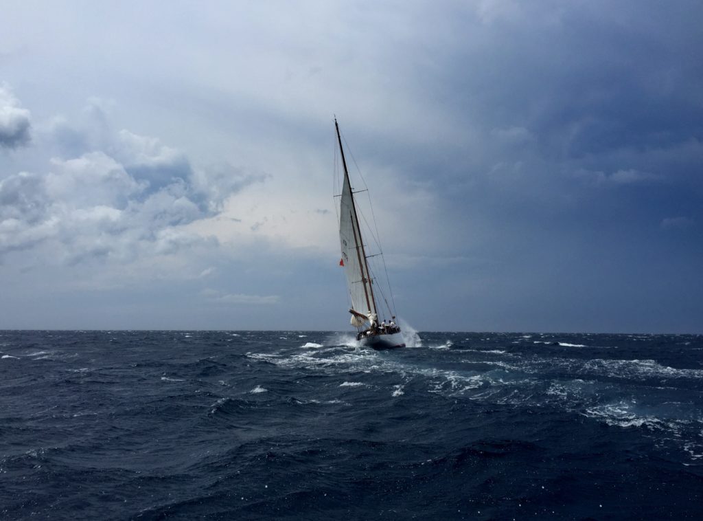 a sailboat in the middle of a stormy sea